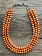 Load image into Gallery viewer, Chunky Multi 3 Strand Statement Necklace, orange peel beaded jewelry, shiny orange jewelry, chunky bib metallic ball beads