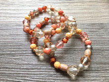 Load image into Gallery viewer, Peach Chunky Statement Necklace & Stretch Bracelet set, Triple Strand Beaded Jewelry, coral pink jewelry, peach bridesmaid marigold gold
