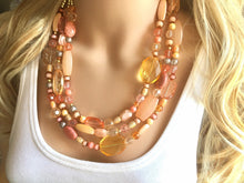 Load image into Gallery viewer, Peach Chunky Statement Necklace & Stretch Bracelet set, Triple Strand Beaded Jewelry, coral pink jewelry, peach bridesmaid marigold gold