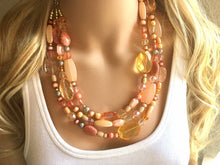 Load image into Gallery viewer, Peach Chunky Statement Necklace & Stretch Bracelet set, Triple Strand Beaded Jewelry, coral pink jewelry, peach bridesmaid marigold gold
