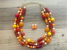 Load image into Gallery viewer, Crisp Fall Breeze Chunky Statement Necklace, Big beaded jewelry, multi strand Statement Earrings, chunky bib orange yellow mustard brown