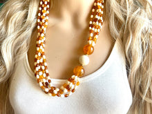 Load image into Gallery viewer, Orange & Cream Statement Necklace, 6 strand chunky long necklace, teal jewelry, warm orange white acrylic vintage beaded necklace