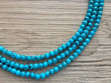 Load image into Gallery viewer, Teal Blue + Black 3 strand Beaded Statement Necklace, Chunky Bib white and Teal Multi-Strand Jewelry Light blue swirl beads ocean side