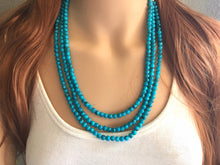 Load image into Gallery viewer, Teal Blue + Black 3 strand Beaded Statement Necklace, Chunky Bib white and Teal Multi-Strand Jewelry Light blue swirl beads ocean side