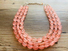 Load image into Gallery viewer, Peach Chunky Statement Necklace &amp; Stretch Bracelet set, Triple Strand Beaded Jewelry, light coral pink jewelry, bridesmaid jelly bean